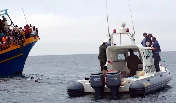 Tunisian coastguards rescue overloaded migrant vessel coming from Libya, on the Tunisian coast, 4 June 2011. (AFP)