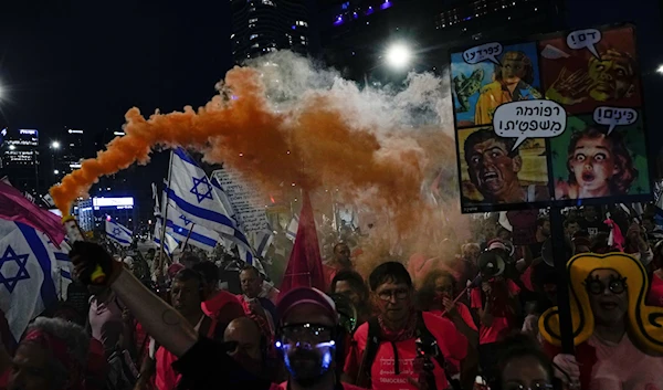 Illegal Israeli settlers protest against plans by Prime Minister Benjamin Netanyahu's government to overhaul the judicial system, in 'Tel Aviv', occupied Palestine, April 8, 2023 (AP)