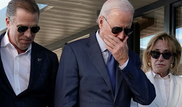 President Joe Biden stands with his son Hunter Biden, left, and sister Valerie Biden Owens, right, as he looks at a plaque dedicated to his late son Beau Biden while visiting Mayo Roscommon Hospice in County Mayo, Ireland, Friday, April 14, 2023 (AP)