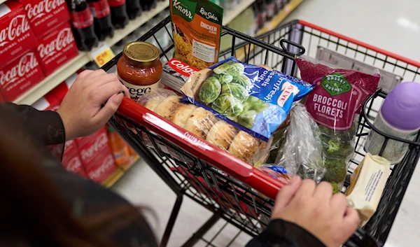 A cart holding groceries is pushed through a supermarket in Bellflower, Calif., on Monday, Feb. 13, 2023. (AP)