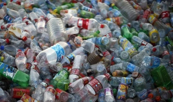 Plastic bottles ready for processing sit at a recycling center. (AP Photo)