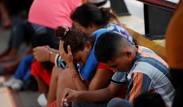 Asylum seekers gather on May 12 on the Matamoros-Brownsville International Border bridge between the US and Mexico, in the wake of Title 42 expiring (Reuters)