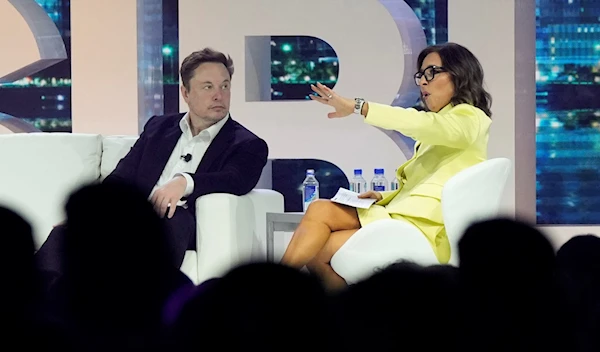 Twitter CEO Elon Musk, center, speaks with Linda Yaccarino, chairman of global advertising and partnerships for NBC, at the POSSIBLE marketing conference, Tuesday, April 18, 2023, in Miami Beach, Florida. (AP)