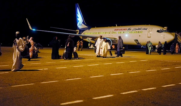 Sudanese, who had been stranded in Jeddah, Saudi Arabia, arrive at Port Sudan airport, Thursday, May 11, 2023 (AP Photo/Amr Nabil)