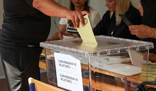 [3/11] A voter casts a ballot at a polling station during the presidential and parliamentary elections, in Hatay, Turkey on May 14, 2023 (Reuters)