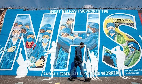 A tribute mural to honour NHS staff and key workers in Belfast, Northern Ireland, created by artists Marty Lyn and Micky Doherty. (AFP)