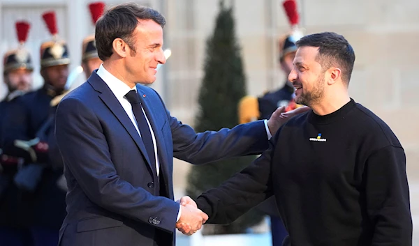 French President Emmanuel Macron, right, welcomes Ukrainian President Volodymyr Zelenskyy at the Elysee palace in Paris, Sunday, May 14, 2023. (AP)