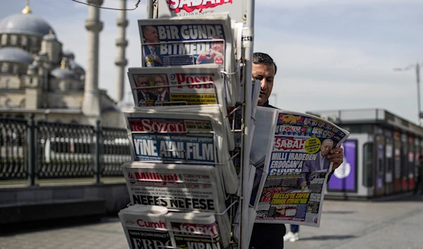 A man reads a Turkish newspaper a day after the presidential election day, in Istanbul, Turkey, Monday, May 15, 2023 (AP Photo/Emrah Gurel)