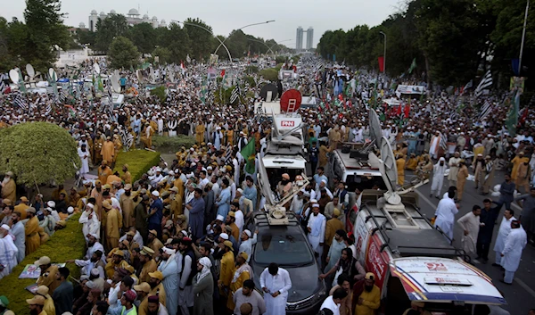 Supporters of Pakistan Democratic Movement, an alliance of the ruling political parties, attend a rally outside the Supreme Court, top left in Islamabad, Pakistan, May 15, 2023 (AP)