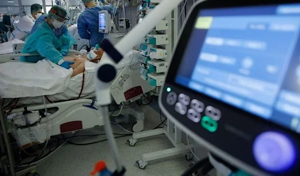 Medical staff members treat patients inside the coronavirus disease (COVID-19) ward at the Central Clinical Hospital of the Ministry of Interior and Administration in Warsaw, Poland, January 11, 2022. (Reuters)