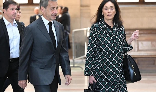 Former French President Nicolas Sarkozy arrives at a Paris courthouse with his lawyer Jacqueline Laffont on May 17, 2023. (AFP)