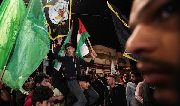 Palestinians celebrate the announcement of a cease-fire after five days of Israeli aggression on Gaza, Gaza City, occupied Palestine, May 13, 2023 (AP)