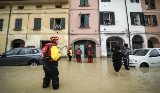 Firefighters talks with residents of the flooded village of Castel Bolognese, Italy, on May 17, 2023. (AP)