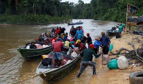 People who were working in illegal mining arrive in boats at Porto do Arame after leaving the Yanomami indigenous land, in Alto Alegre, Roraima state, Brazil, February 12, 2023. REUTERS/Amanda Perobelli/File Photo