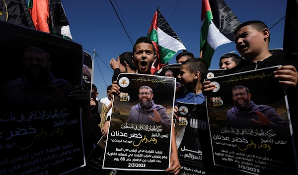 Palestinian youth show rage over the Israeli Occupation's murder of prisoner turned Martyr Sheikh Khader Adnan. (AP)