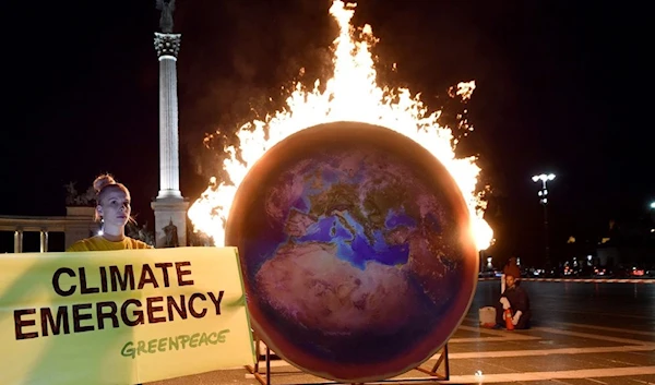 The Earth on fire is seen during a Greenpeace protest at the Heroes square in Budapest on Sept. 4, 2019. (Attila Kisbenedek/AFP/Getty Images)