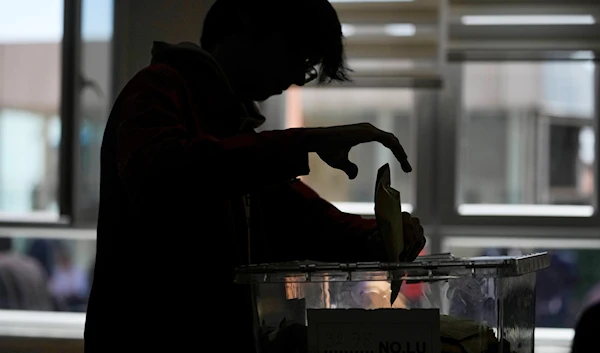 A young man votes at a polling station in Istanbul, Turkey, Sunday, May 14, 2023. (AP)