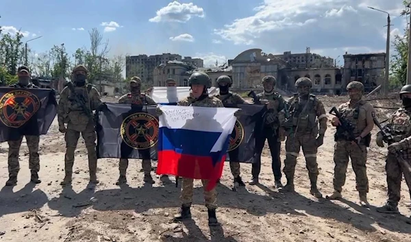 The commander of the Wagner Group, Yevgeny Prigozhin, with Russian soldiers and private military contractors in Bakhmut, May 20, 2023 (Screengrab from social media)