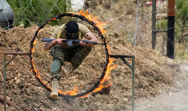 A Fighter from the Lebanese militant group Hezbollah carries out a training exercise in Aaramta village in the Jezzine District, southern Lebanon, Sunday, May 21, 2023. (AP)