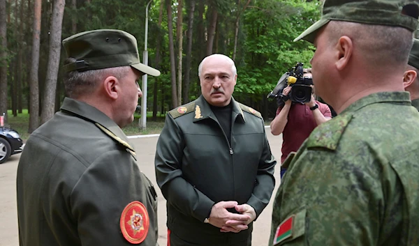 Belarusian President Alexander Lukashenko, center, speaks to officers as he visits the Central Command Post of the Air Force and Air Defense Forces in Belarus, Monday, May 15, 2023 (AP)