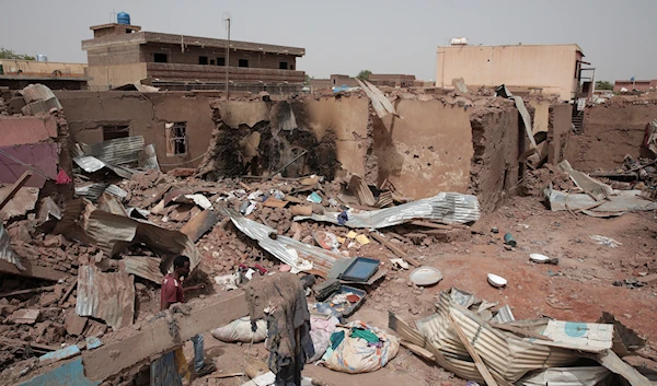 A man walks by a house hit in recent fighting in Khartoum, Sudan, April 25, 2023. (AP)