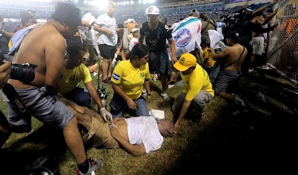 First responders tend to a casualty of the stampede that occurred in the Cuscatlan Stadium, San Salvador, El Salvador,  20 May 2023. (AFP)