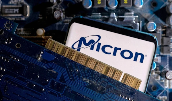 A smartphone with a displayed Micron logo is placed on a computer motherboard in this illustration taken March 6, 2023 (reuters)