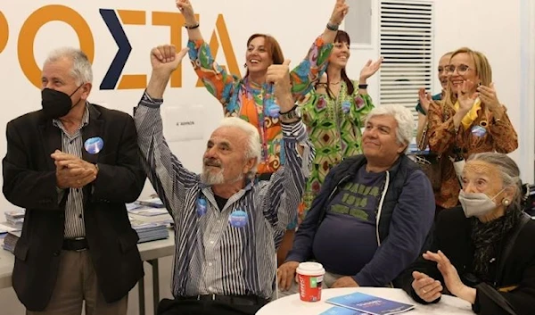 Supporters of New Democracy conservative party react at the party's main election kiosk after the announcement of the first exit polls, in Athens, Greece, May 21, 2023. (Reuters)