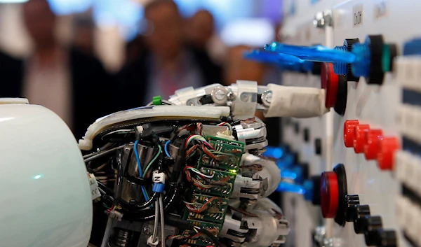 The hand of an artificial intelligence lightweight android operates a switchboard during a demonstration. (Reuters)