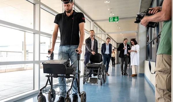 Gert-Jan, who is paralysed, walks using new technology that decodes his brain's signals. (AFP)