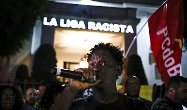 A message that reads in Portuguese; "La Liga racist" is projected onto the Spanish Consulate, as people gather outside to protest against racism suffered by Brazilian soccer star Vinicius Junior, Tuesday, May 23, 2023. (AP)