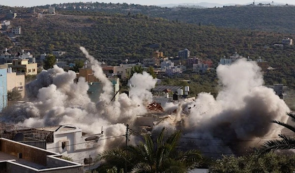 Israeli occupation blow up a Palestinian house in Qarawat Bani Hassan in the Israeli-occupied West Bank July 26, 2022. (Reuters)