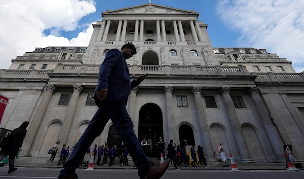 A man walks past the Bank of England, at the financial district in London, Thursday, May 11, 2023. (AP)