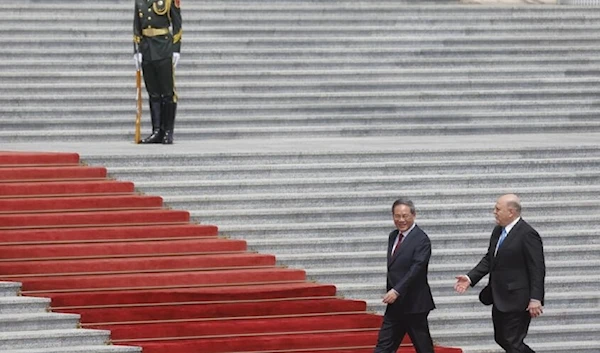 Russian Prime Minister Mikhail Mishustin (R) and Chinese Premier Li Qiang attend a welcoming ceremony in Beijing. (AFP)