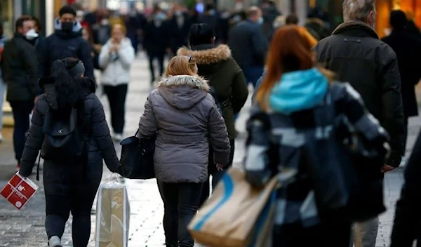 People carry bags on Hohe Strasse shopping street in Cologne, Germany. (Reuters)