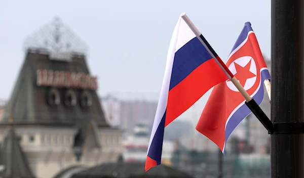 Flags of Russia and North Korea are seen in front of the central railway station in Vladivostok, Russia, Wednesday, April 24, 2019. (AP)