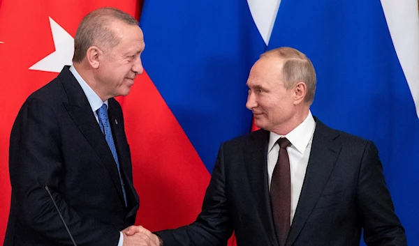 Russian President Vladimir Putin and Turkish President Tayyip Erdogan shake hands during a news conference following their talks in Moscow, Russia March 5, 2020 (Reuters)