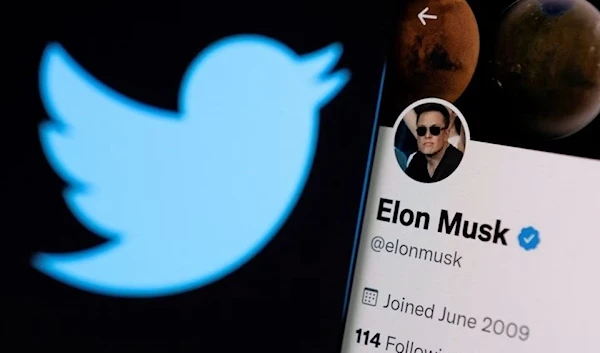 A Twitter logo is displayed in front of Elon Musk's Twitter account, April 15 2022. (Reuters)