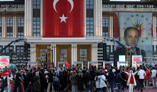 Supporters of the President Recep Tayyip Erdogan gather outside the Presidential Palace in Ankara, Turkey, May 28, 2023 (AP)