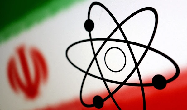 An atom symbol is placed ahead of the flag of the Islamic Republic of Iran, July 21 2022. (Reuters)