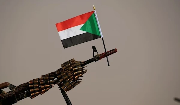 The flag of Sudan is attached on the muzzle of a machine gun belonging to the Rapid Support Forces (RSF) Aprag, Khartoum, Sudan, June 22 2019. (Reuters)