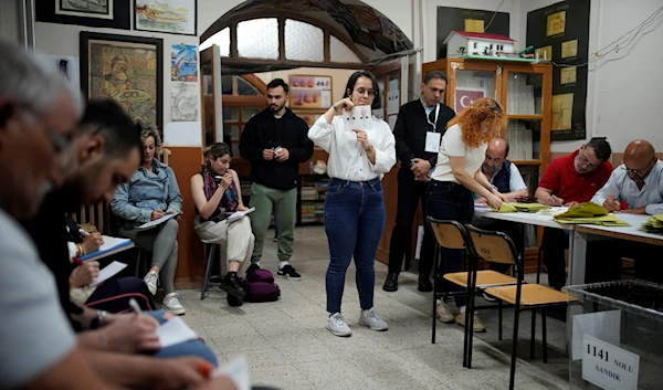 Election representatives count the ballots at a polling station in Istanbul, Turkey, Sunday, May 28, 2023 (AP Photo/Emrah Gurel)