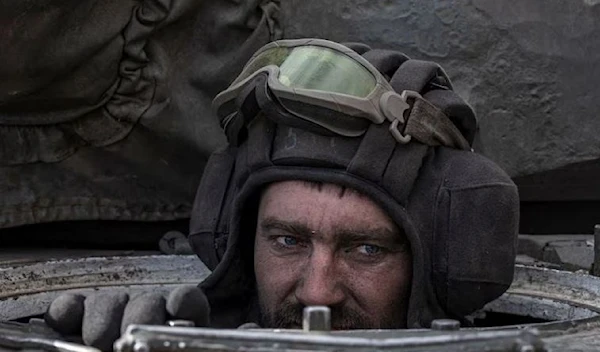 A Ukrainian serviceman sits inside a tank in the village of Lukyanivka outside Kiev, Ukraine, March 27, 2022. (Reuters)