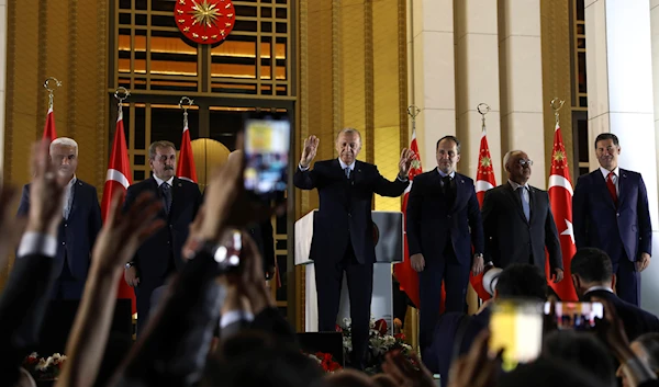 Turkish President and People's Alliance's presidential candidate Recep Tayyip Erdogan, center, gestures to supporters at the presidential palace, in Ankara, Turkey, May 28, 2023 (AP)