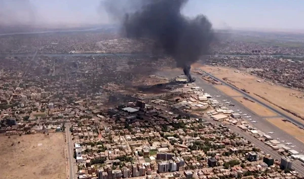 An aerial view shows black smoke rising above the Khartoum International Airport in Khartoum, Sudan, on April 20, 2023. (AFP)