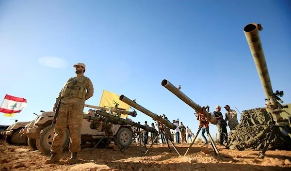 A Hezbollah freedom fighter stands in front of anti-tank artillery weapons in Arsal at the Lebanese-Syrian border, July 29 2017. (Reuters)