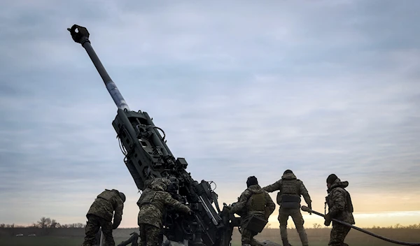 Ukrainian soldiers operate a U.S.-supplied M777 howitzer in Kherson region, Jan. 9, 2023 (AP Photo/Libkos, File)