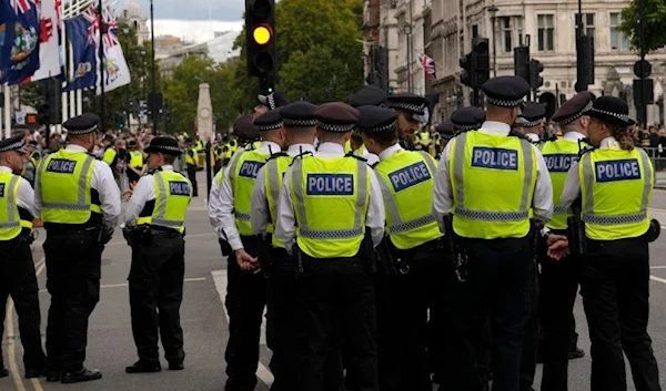 Police officers wait in Westminster in London, Sunday, Sept. 18, 2022. (AP)