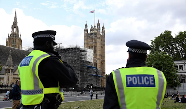 British police officers keep a watchful eye on people at a protest, organised by Black Lives Matter, at the Parliament Square in central London, Sunday, June 21, 2020. (AP)