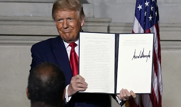 President Donald Trump holds a signed Constitution Day proclamation after he spoke to the White House conference on American History at the National Archives museum, Thursday, Sept. 17, 2020, in Washington. (AP)